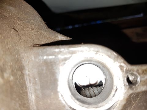 1978 Ford Bronco - A detailed view of an engine part, showing internal components and metal texture.