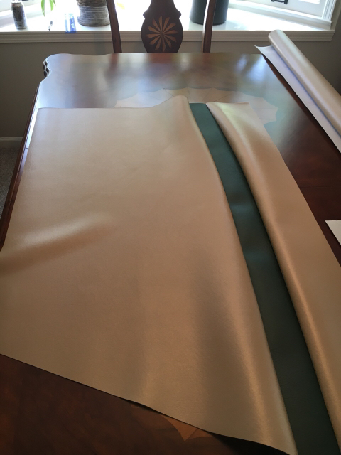 1996 Ford Bronco - Material is spread across a wooden table, with a roll of material visible in the background.