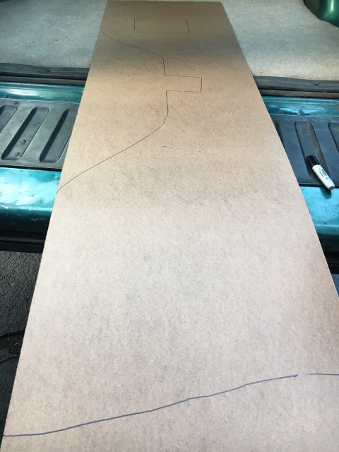 1996 Ford Bronco - A template is laid out in the back of a vehicle, ready for cutting.