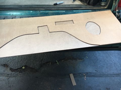 1996 Ford Bronco - A custom-shaped cardboard template lies on the ground, suggesting a part for a vehicle.