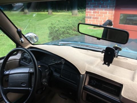 1996 Ford Bronco - Interior view of a 1996 Ford Bronco, including the dashboard, steering wheel, and a phone mount.
