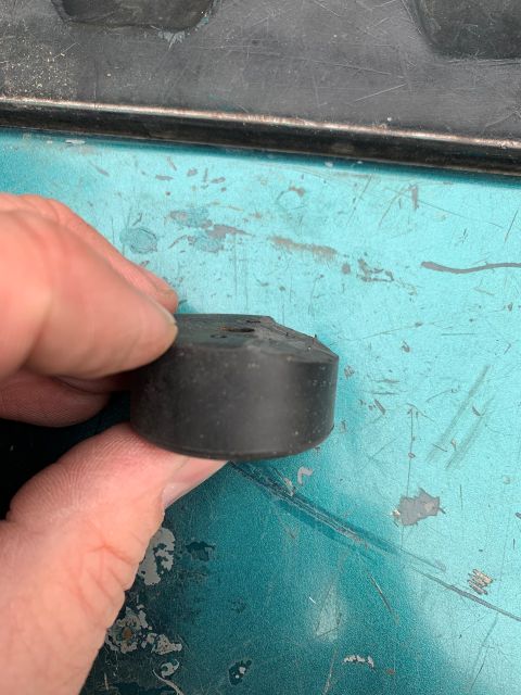 1996 Ford Bronco - A rubber bumper is held by a hand, with a Supermotors.net logo visible in the lower right corner.
