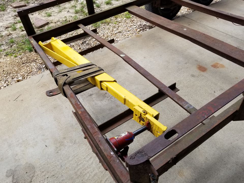 To straighten them, I used a 2-post lift arm, a heavy commercial ratchet strap, and a bottle jack.