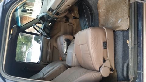 1995 Ford Bronco - Interior view of a 1995 Ford Bronco, highlighting the tan leather seats and dashboard details.