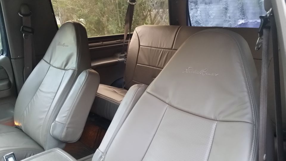 Front leather seats with Eddie Bauer embroidery. Rear bench seat visible