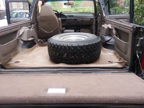 1995 Ford Bronco - The interior of a Ford Bronco shows a spare tire and the dashboard.