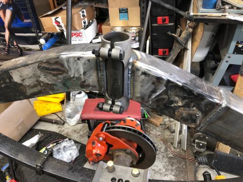 1992 Jeep Wrangler - A close-up view of a custom fabricated suspension component, likely for a Jeep Wrangler, with a brake caliper and rotor assembly attached.…