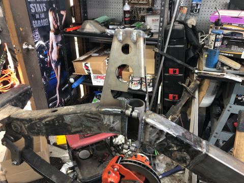 1992 Jeep Wrangler - A close-up view of a custom-fabricated metal frame assembly, likely for a vehicle, with visible welding and unfinished metal surfaces. The…