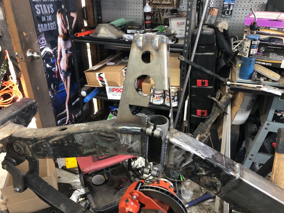 Custom metal frame assembly with welding in a workshop.