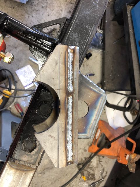 1992 Jeep Wrangler - A close-up view shows a freshly welded metal bracket attached to a black metal frame. The weld bead is prominent and runs vertically along…