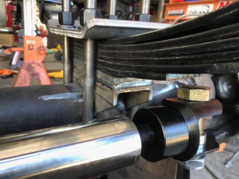 1992 Jeep Wrangler - A close-up view shows a custom suspension setup on a vehicle, featuring multiple leaf springs held by U-bolts and a custom fabricated brack…