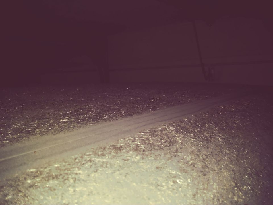 Close-up of textured vehicle undercarriage or floor with a light stripe.