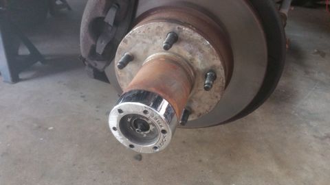 1996 Ford Bronco - Close-up of a vehicle's front wheel hub, showing the brake rotor and locking mechanism.