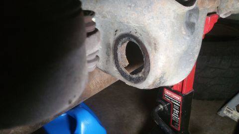 1996 Ford Bronco - A close-up view of a vehicle's suspension component, showing signs of wear and rust.