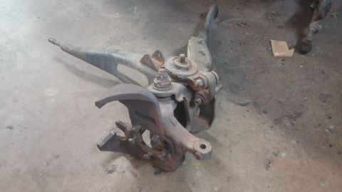 1996 Ford Bronco - A rusty front suspension spindle assembly is shown, likely a replacement part.