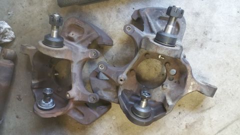 1996 Ford Bronco - Two used steering knuckles, likely for a 1990s era truck or SUV, are shown with their ball joints attached.