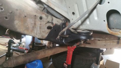 1996 Ford Bronco - Close-up view of the vehicle's undercarriage, highlighting suspension components and frame structure.