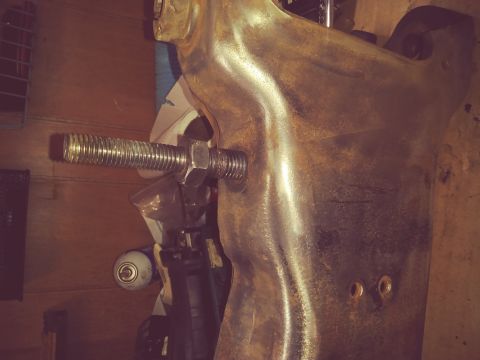 1996 Ford Bronco - A close-up view of a vehicle suspension part, a prominent bolt and nut assembly.