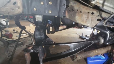 1996 Ford Bronco - Close-up view of the front suspension system, showing various mechanical parts and linkages.