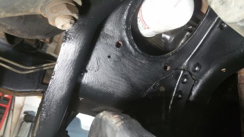 1996 Ford Bronco - Close-up view of a vehicle's front suspension components, including an oil filter.