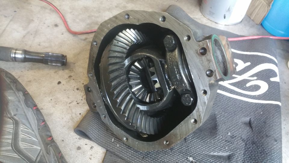 Differential housing with internal gears and a driveshaft end visible