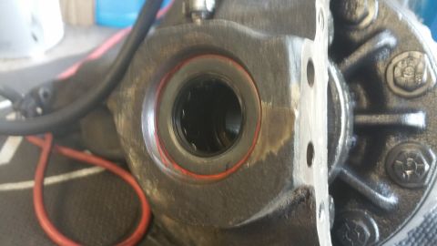 1996 Ford Bronco - This is a close-up view of a vehicle's differential housing, showing internal components and external bolts.