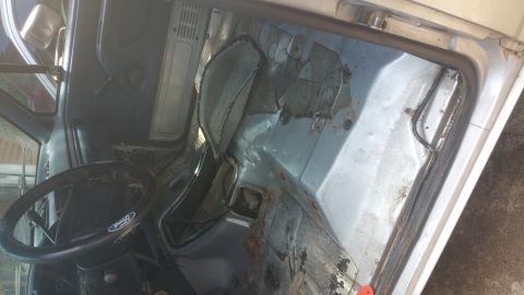 1996 Ford Bronco - The interior of the vehicle shows significant wear and tear, with exposed metal and damaged upholstery.