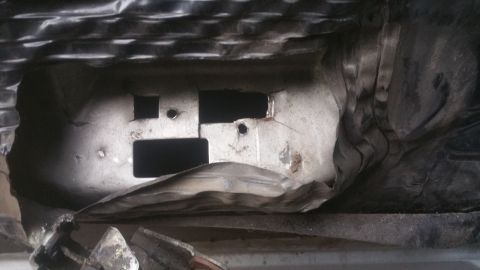 1996 Ford Bronco - This image shows the underside of a vehicle, revealing structural components and insulation material.