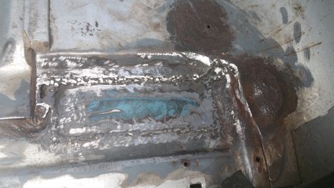 1996 Ford Bronco - This image shows a section of rusted metal with visible welds, likely part of a vehicle's frame.