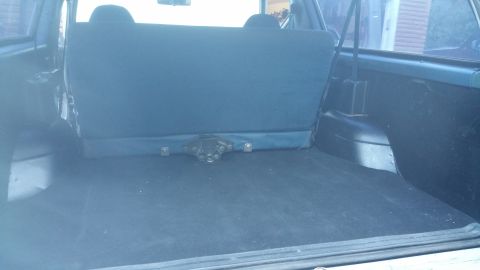 1996 Ford Bronco - The rear cargo area and folded seat of a vehicle are shown.
