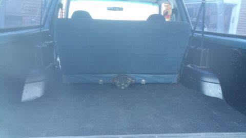 1996 Ford Bronco - The rear cargo area of an SUV, showing the folded rear seat and the floor of the storage space.