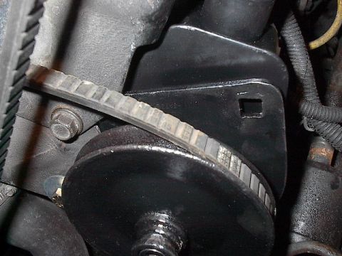 1986 Ford Bronco - Pump in place. Note fender washer to span widened adjustment slot.