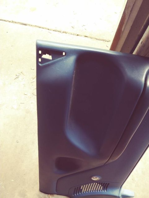 1996 Ford Bronco - A dark gray plastic door panel is shown, possibly from a vehicle's interior.