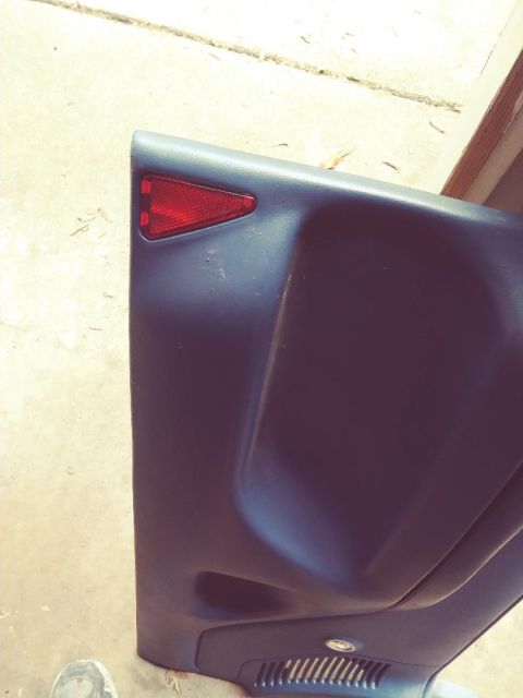 1996 Ford Bronco - A close-up of a car's rear bumper reflector is shown, with a partial view of the interior trim.