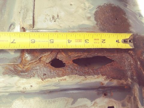 1996 Ford Bronco - Rusted metal section with holes, measured with a tape measure. Supermotors.net logo is present.