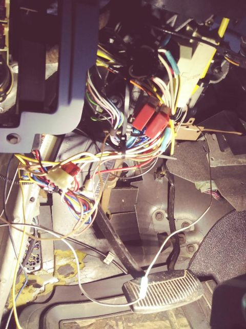 1996 Ford Bronco - The interior wiring harness of a 1996 Ford Bronco is visible, numerous colorful wires and red connectors.