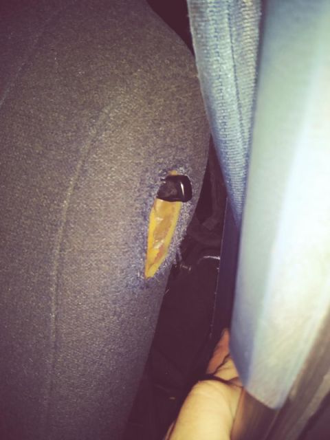 1996 Ford Bronco - Close-up view of damaged seat fabric inside a vehicle.