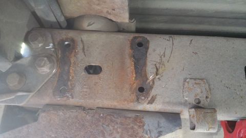 1996 Ford Bronco - Close-up view of heavily rusted suspension components, showing wear and corrosion on the metal.