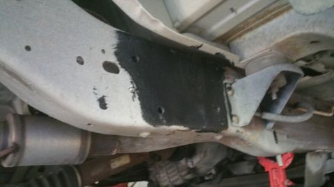 1996 Ford Bronco - Underside view of vehicle frame and suspension components, with visible exhaust pipe.