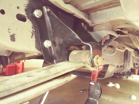 1996 Ford Bronco - Close-up view of vehicle's rear suspension components, including a black bracket and leaf spring.
