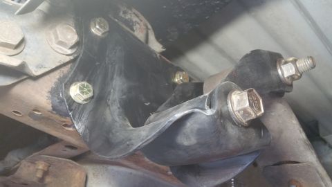 1996 Ford Bronco - Underside view of a vehicle's rear suspension component, showing a rubber bushing and metal bracket.