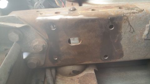 1996 Ford Bronco - Close-up of a vehicle's frame and suspension components, with visible rust and mounting hardware.