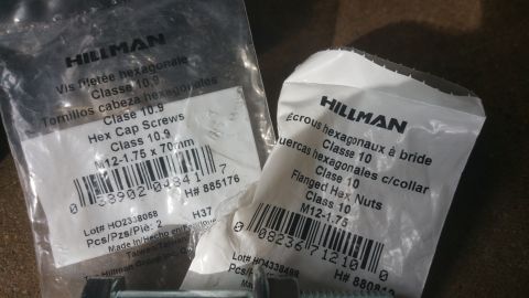 1996 Ford Bronco - Two packages of fasteners, one containing hex cap screws and the other flanged hex nuts, are shown.