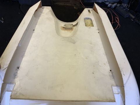 1923 Ford Model T - A white fiberglass car body part is shown from an overhead perspective, revealing its unfinished interior and mounting points.