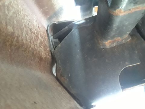 1985 Ford Bronco - Detail of a vehicle's frame and hitch mounting point, showing rust and metal construction.