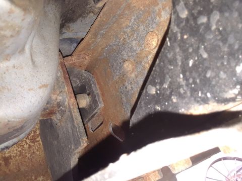 1985 Ford Bronco - Undercarriage view showing rusted metal frame components and suspension elements.