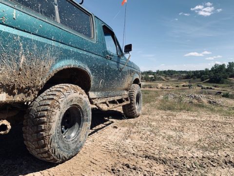 1996 Ford Bronco - This 1996 Ford Bronco is covered in mud after an off-road excursion on a sunny day.