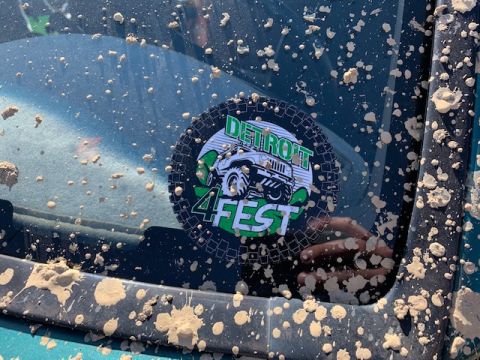 1996 Ford Bronco - A sticker on a muddy vehicle window advertises Detroit 4Fest with an image of a Jeep.