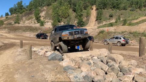 1996 Ford Bronco - A 1996 Ford Bronco tackles an off-road course, demonstrating its capability on challenging terrain.