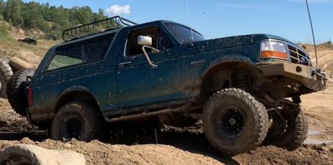 1996 Ford Bronco - This 1996 Ford Bronco is shown tackling a challenging muddy terrain during an off-road excursion.
